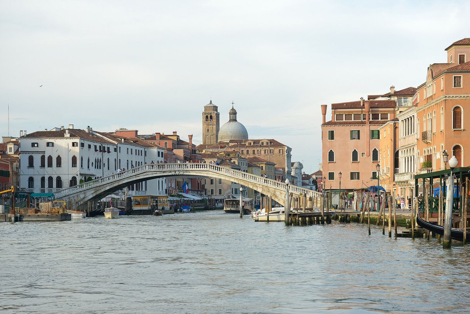 The stone arch of the Ponte degli Scalzi over the Grand Canal, with the dome and bell tower of San Geremia behind
